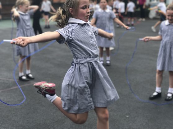 A girl jumping through a skipping rope